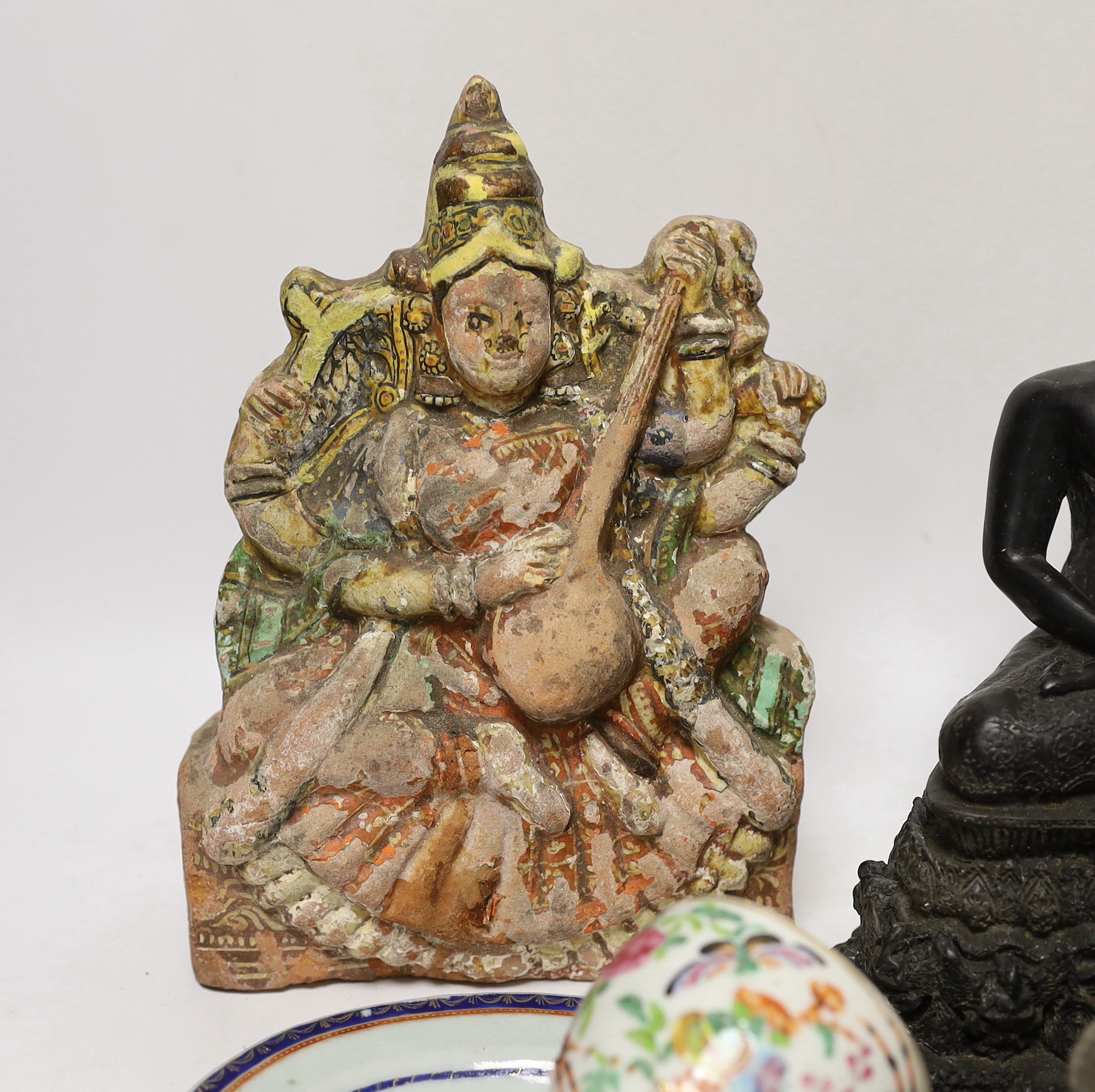 A Thai composite Buddha, an African carved wood female figure, an iron, a small bronze Buddha, larger Buddha 22cm high